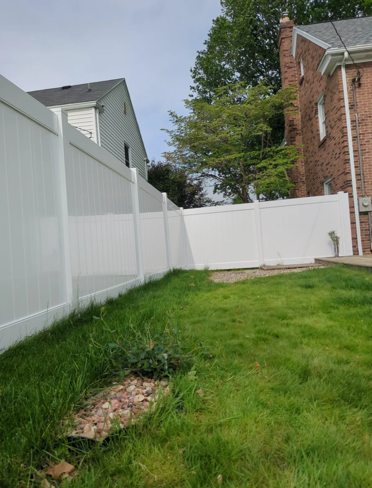 After: new white vinyl privacy fence