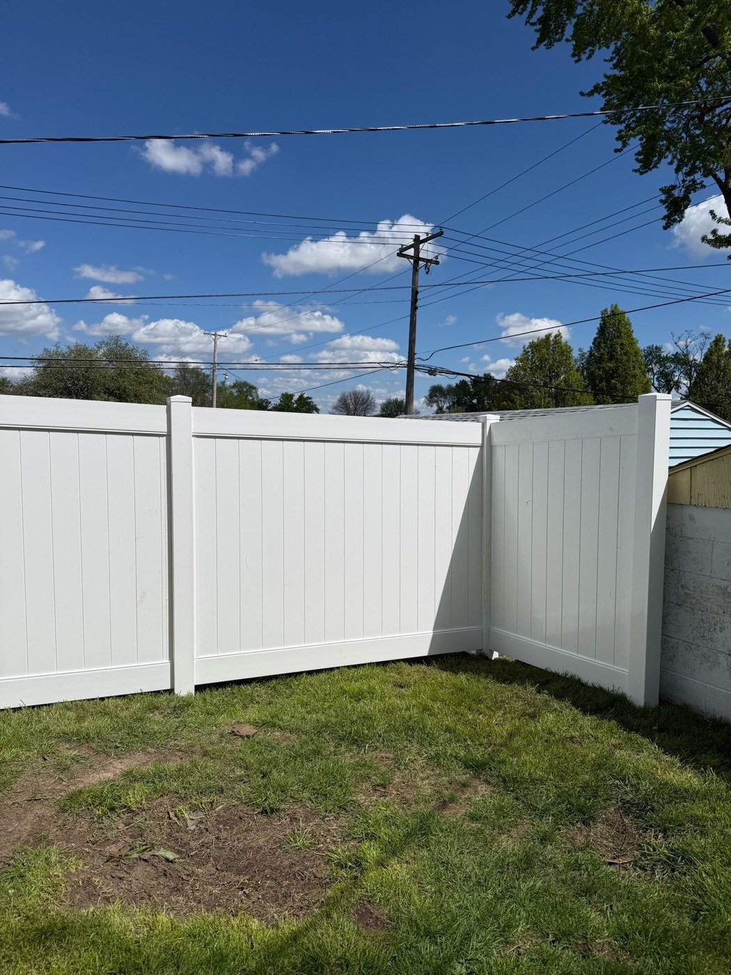 White vinyl privacy fence residential backyard installation, Northern Indiana
