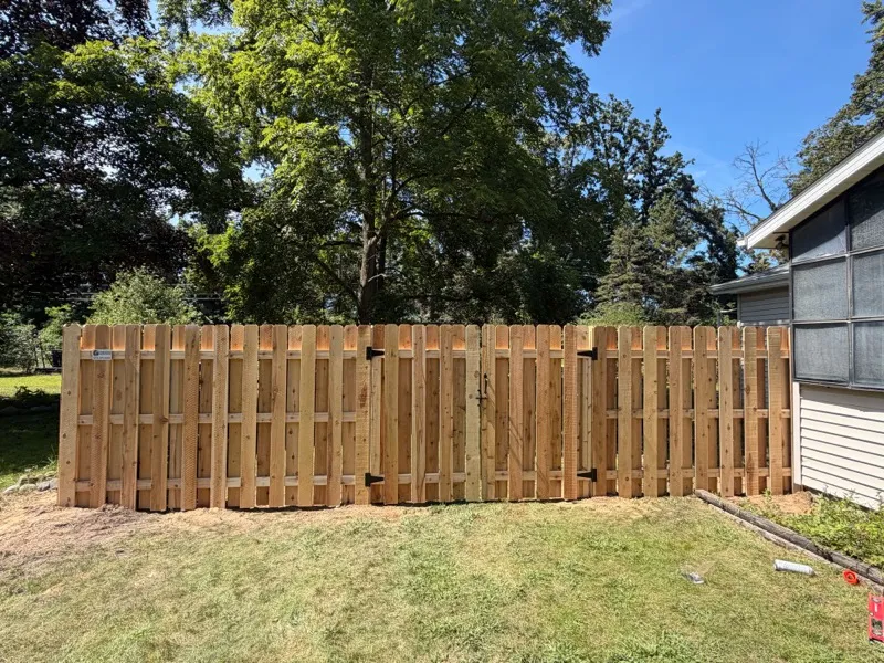 Cedar dog-ear privacy fence with gate, full yard installation in Northern Indiana