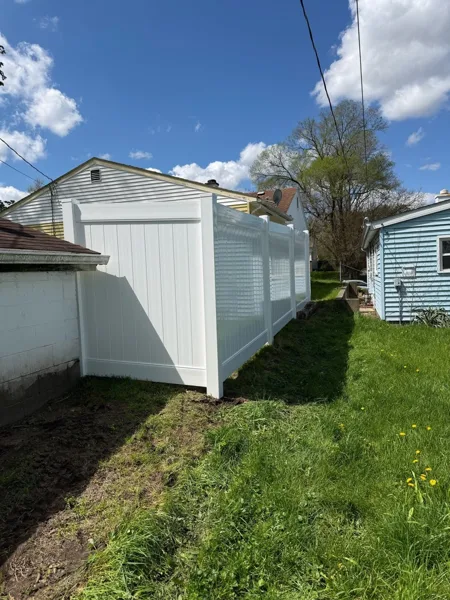 White vinyl privacy fence along property line, Northern Indiana