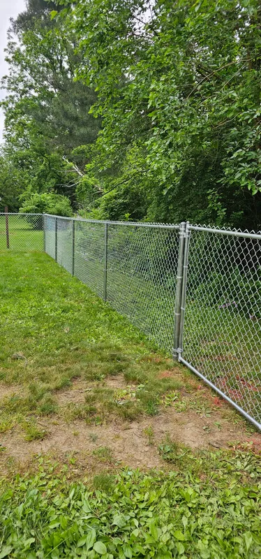 Chain link fence corner with gate post, residential property in Northern Indiana
