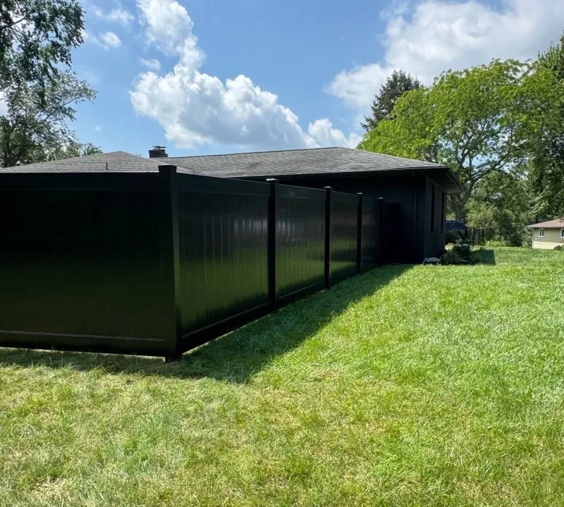 Black vinyl privacy fence with wide sky backdrop, Northern Indiana installation