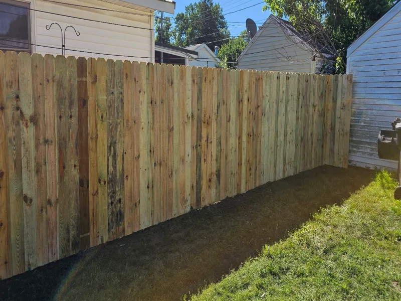 Pressure-treated wood dog-ear privacy fence full yard installation, Northern Indiana